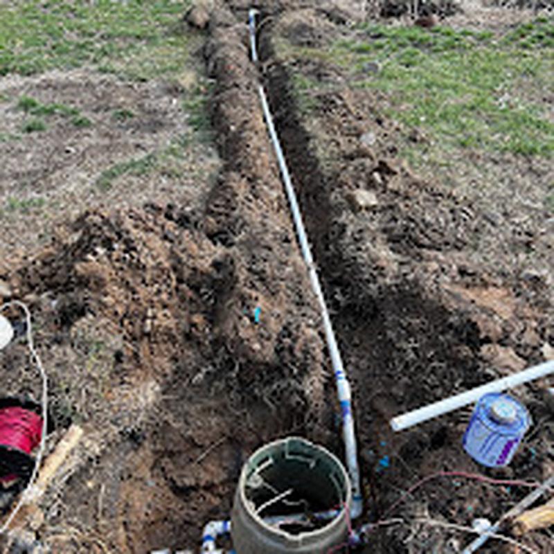 PVC irrigation pipe run laid in an open trench
